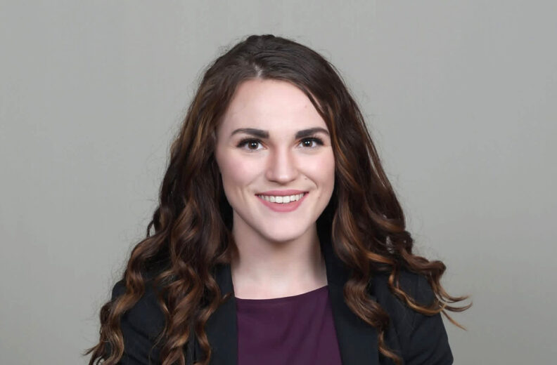 A headshot of Reilly Bealer smiling.