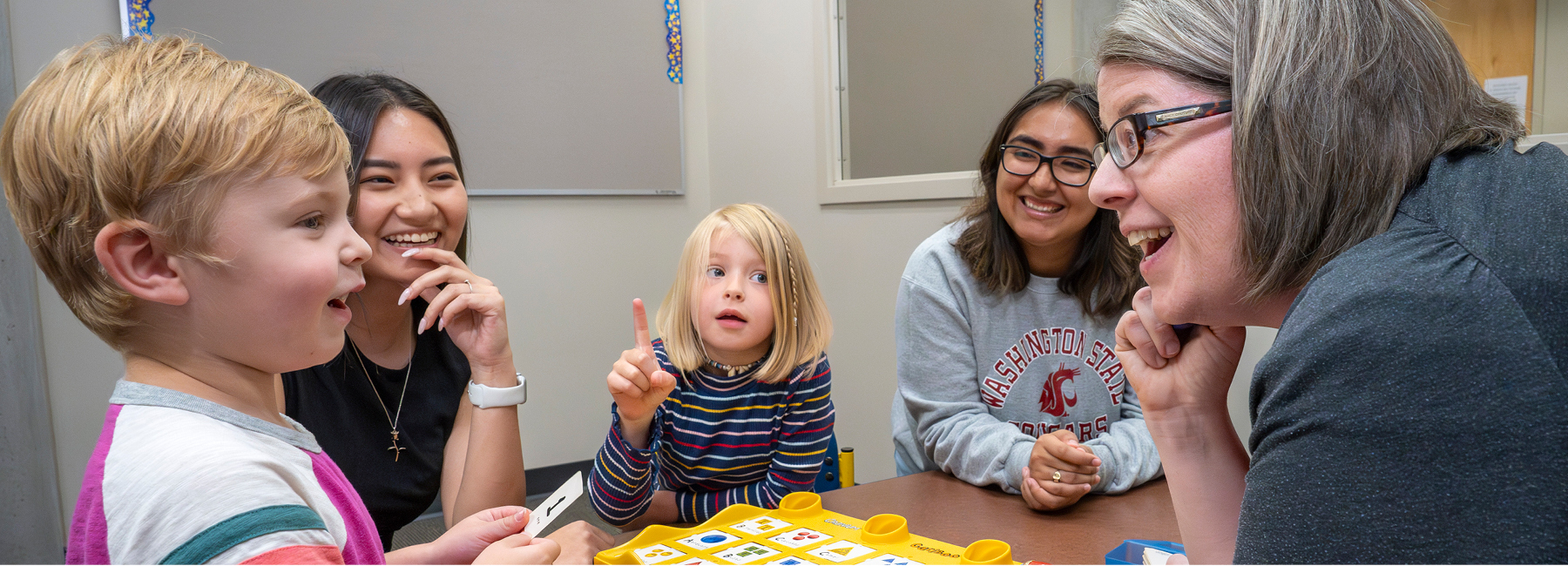 Professor and two student working with childeren in Cab Lab