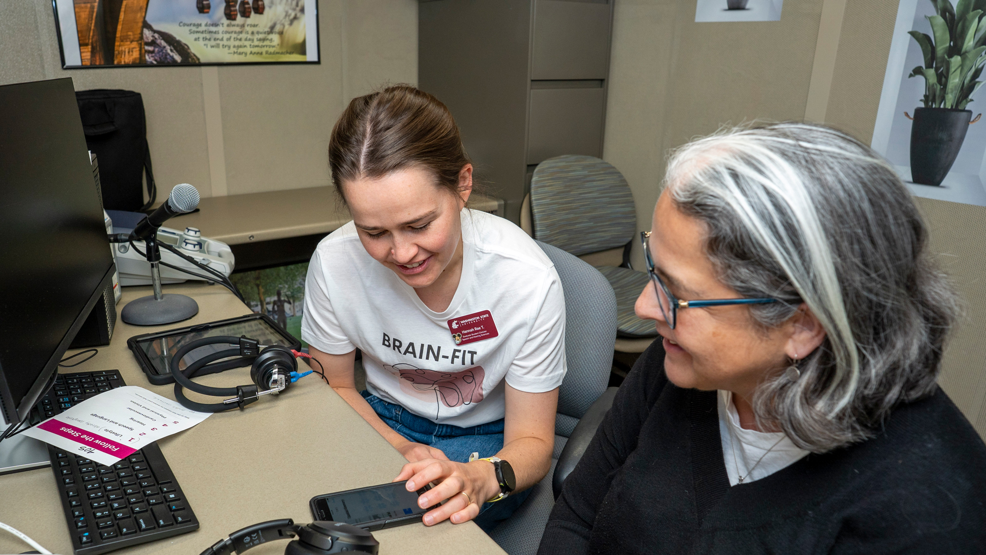 Graduate student giving a brain fit screening using their phone.
