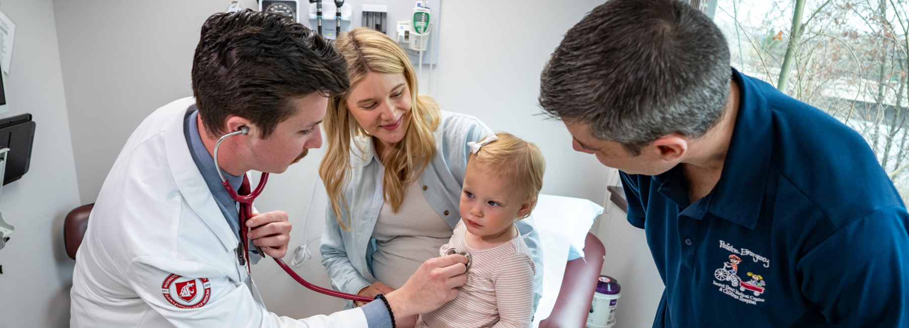 resident checking heart beat of a toddler