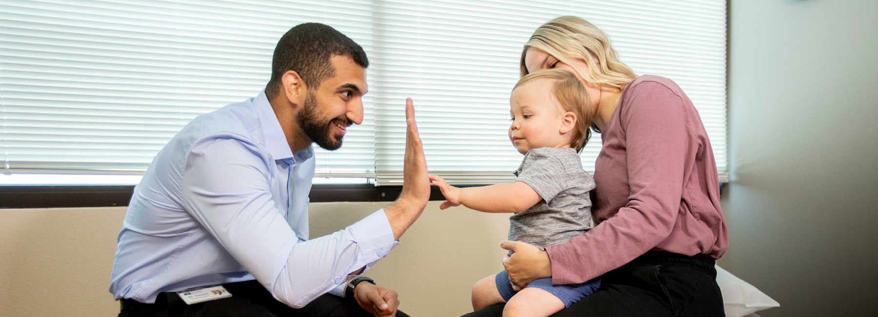 Resident giving a high five to a young child