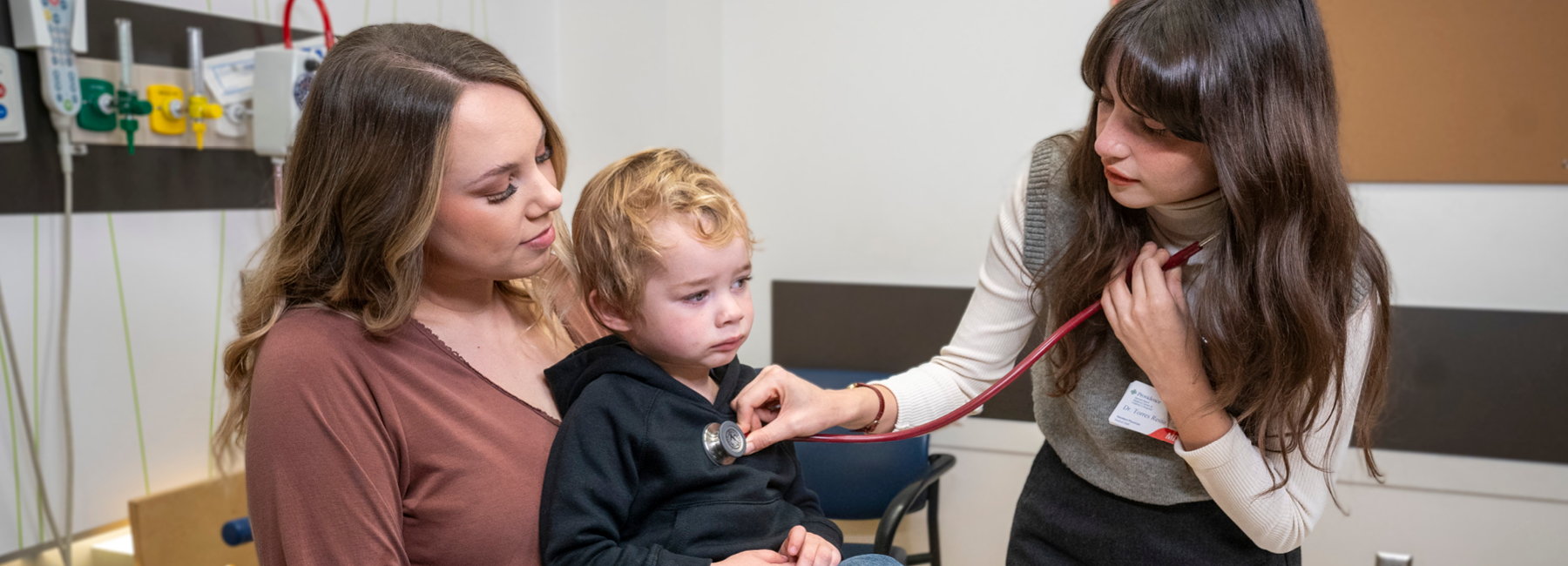 Resident checking heart rate of child