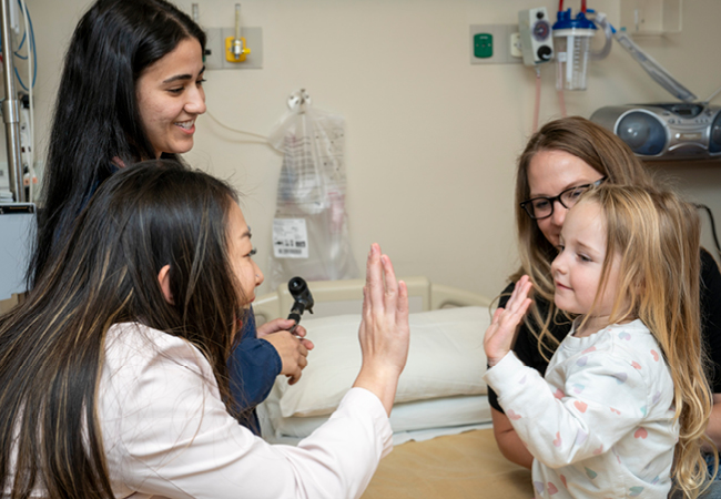 Resident giving a high five to a child
