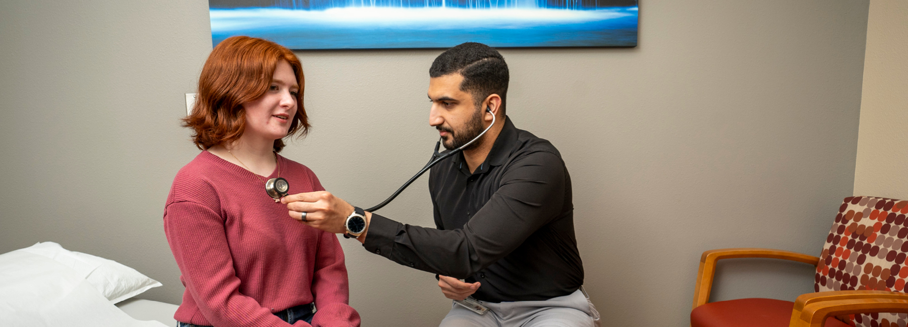 Resident checking heart rate of a teenager.