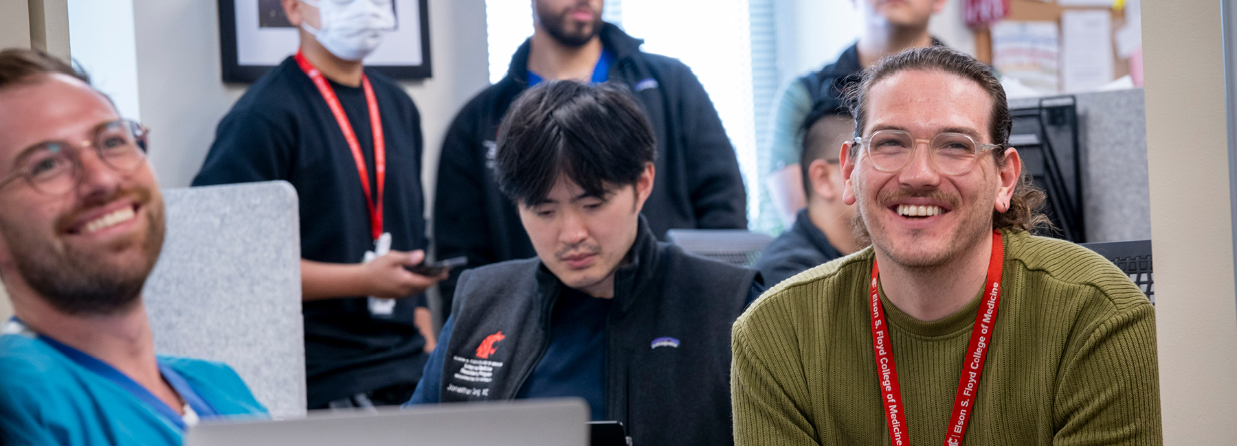 Group of residents smiling in a training session.