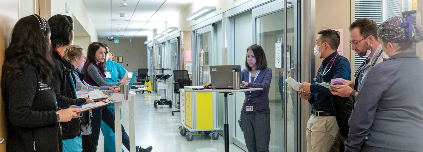 Group of ten doctors having a meeting in the hallway of the hospital.
