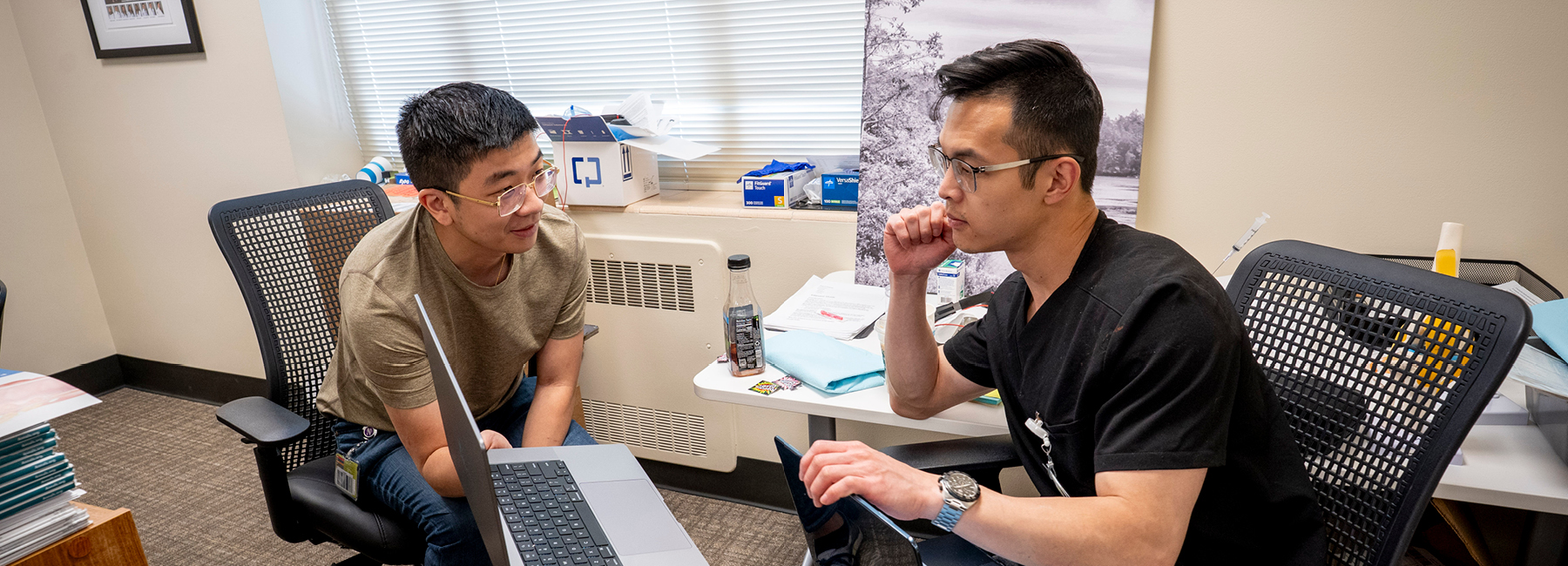 Two residents using a laptop.