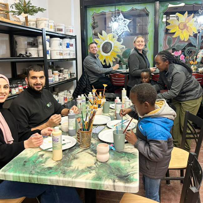 Residents and family painting poetry at a local store.