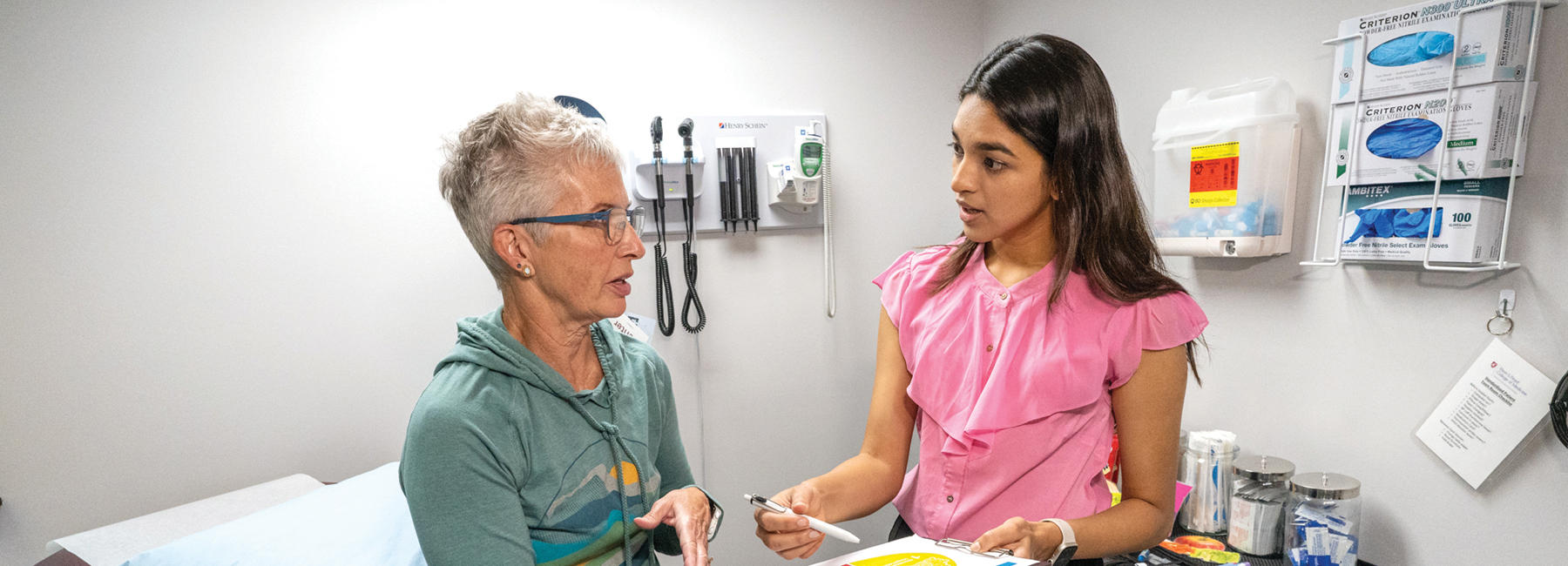 Student showing a chart to a patient
