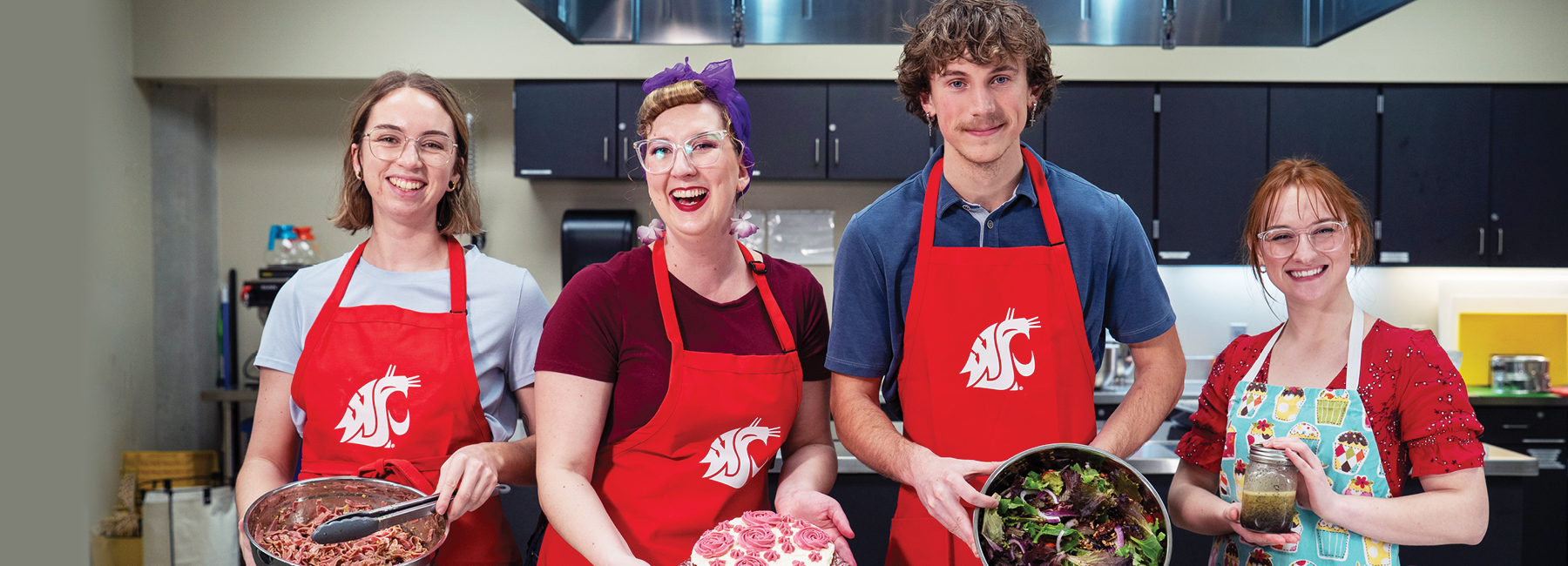 4 students holding the meal they prepped in BS NEP Program