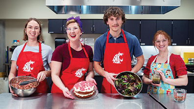4 students holding the meal they prepped in BS NEP Program