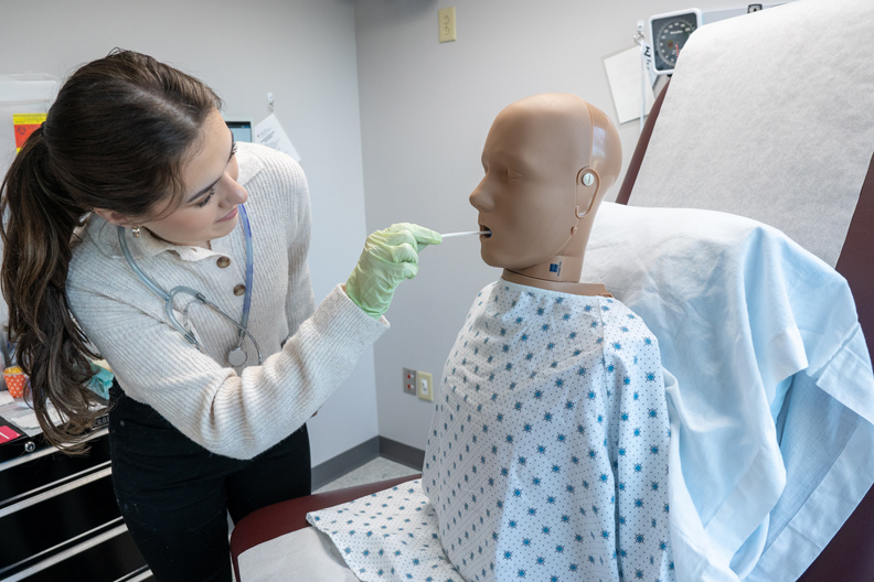 Student swabbing manikin's mouth in Virtual Clinic Center