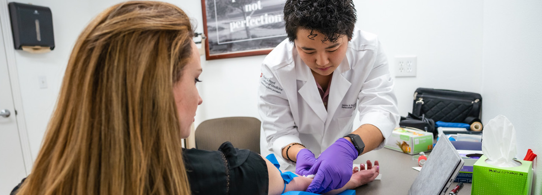 Doctor drawing blood from patient