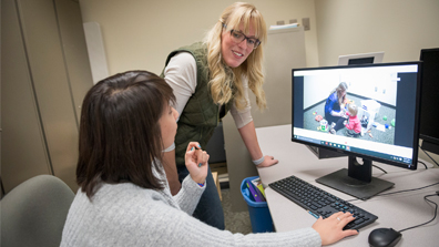 Researchers looking at a computer