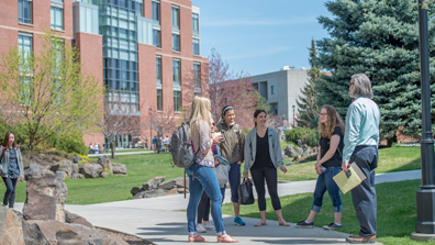 Group of people standing in circle outside