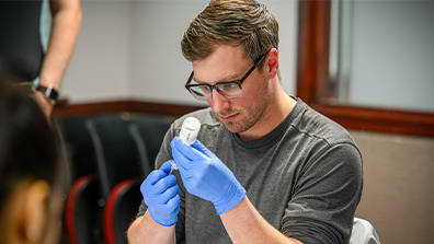 Researcher fill up syringe