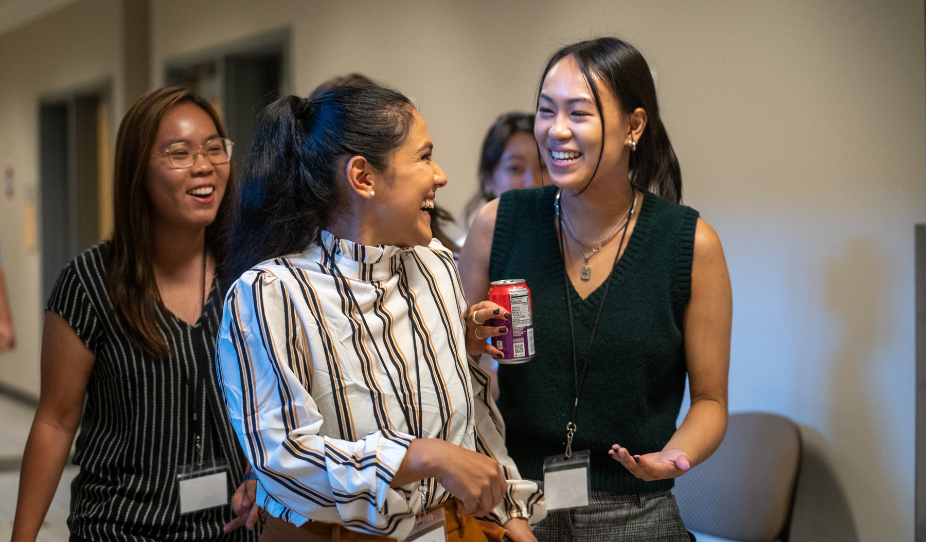 three students walking down a hallway