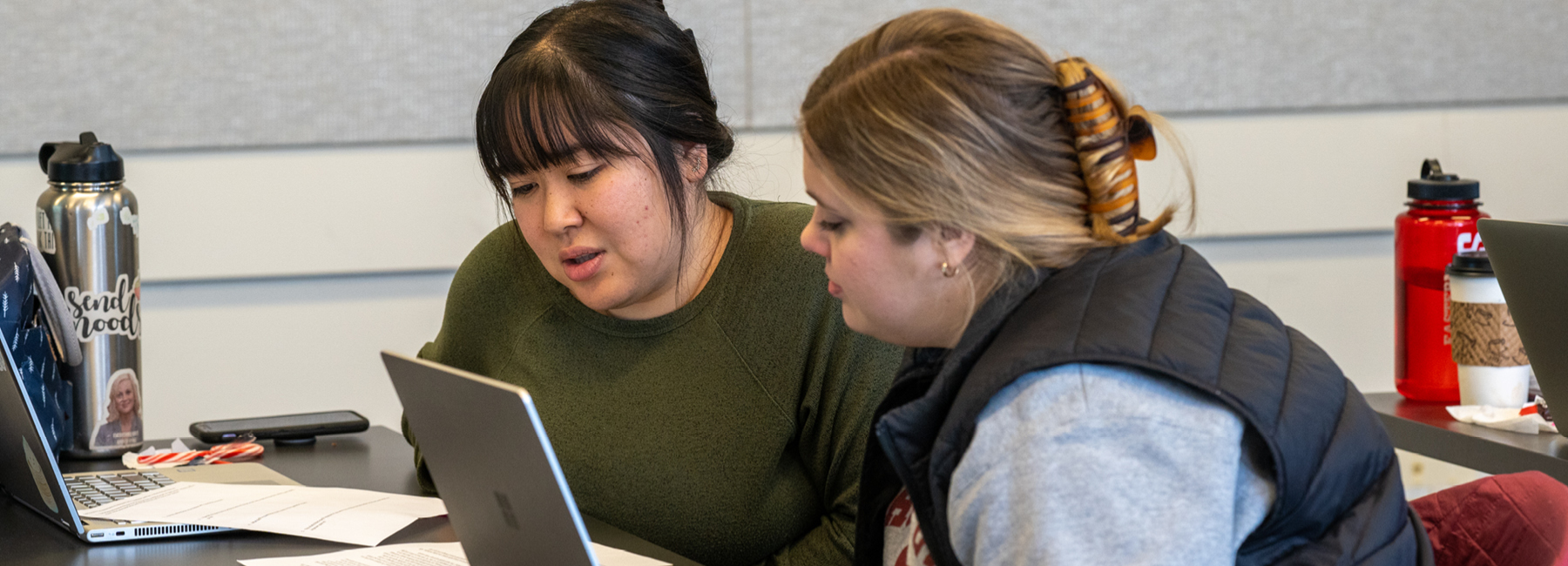 2 people looking at a laptop