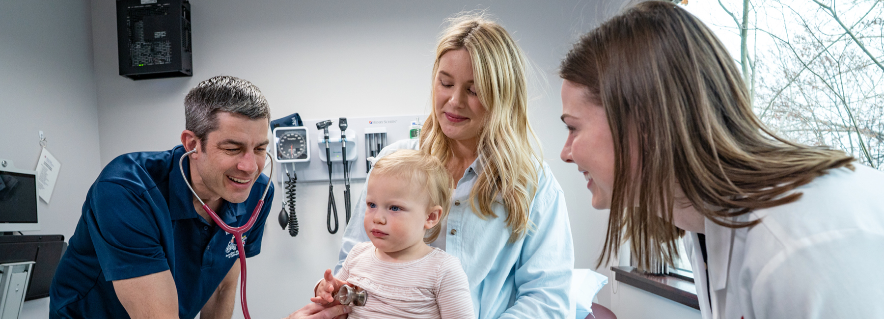 Doctor checking heart rate of a toddler