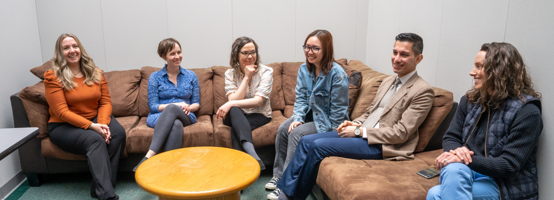 PRISM staff talking on sofa