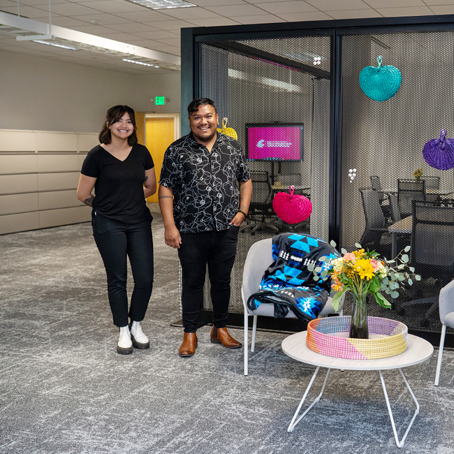 Two people standing in front of the Center for the People room.
