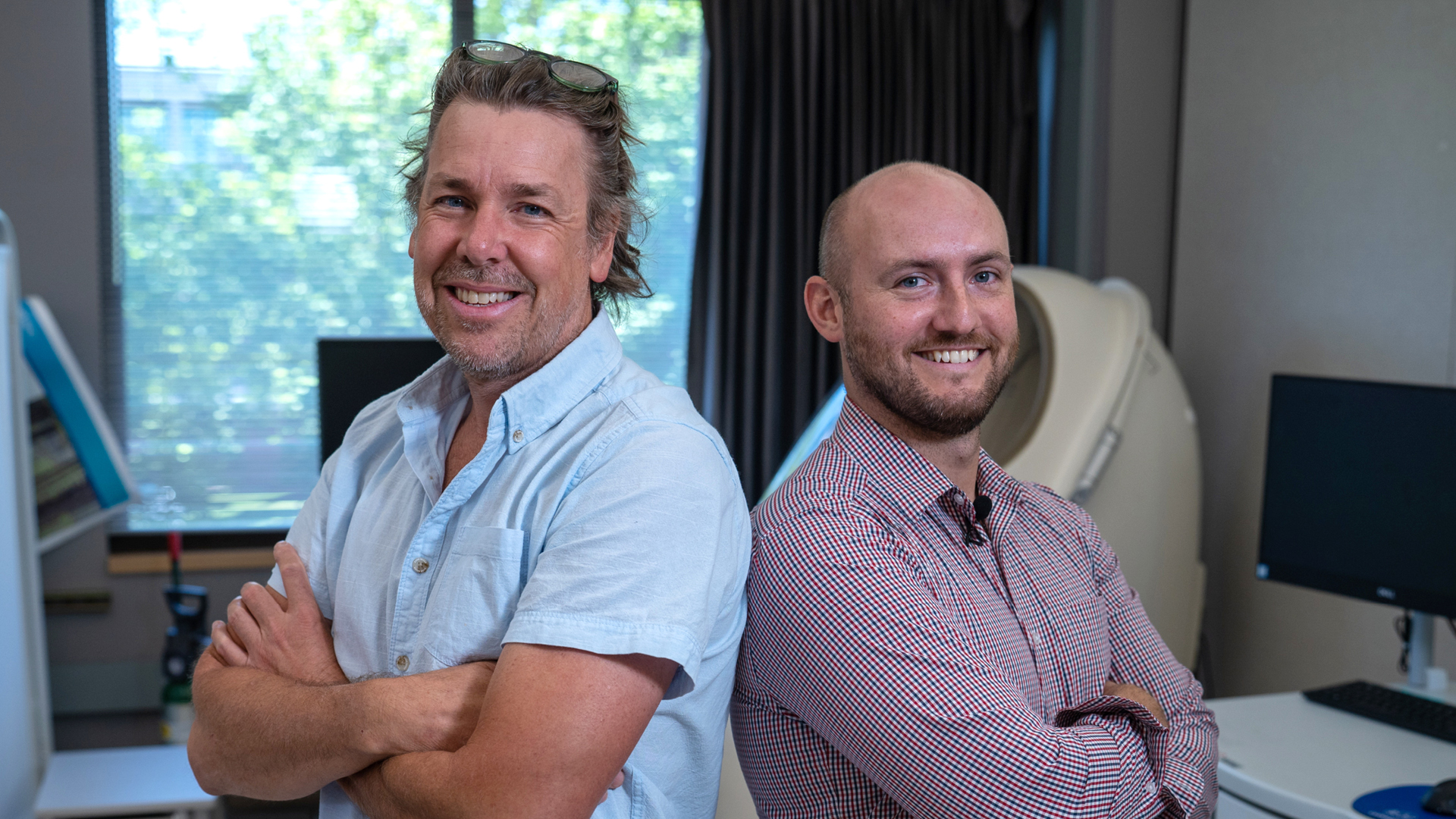 two researchers standing back to back.