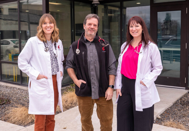 3 providers standing outside the Logan Family Clinic.