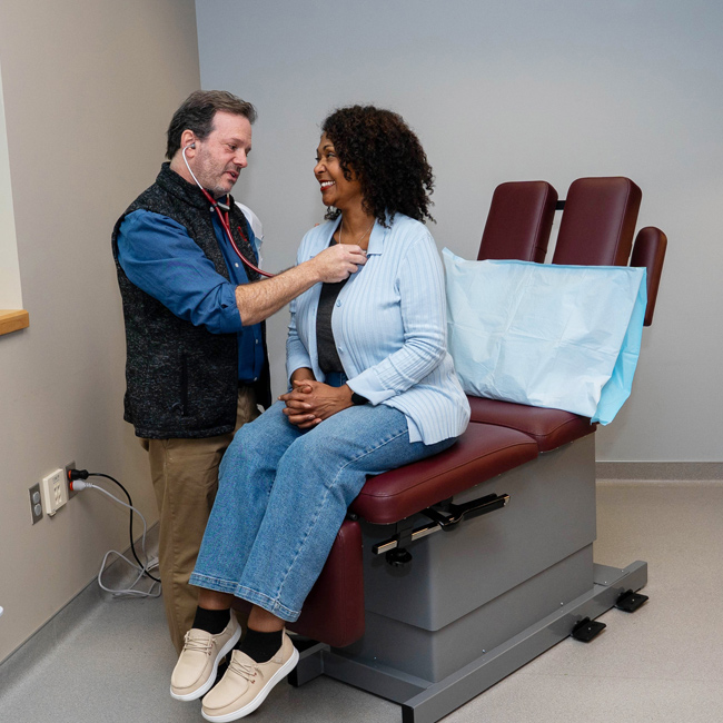 Doctor checking the heart rate of a patient.