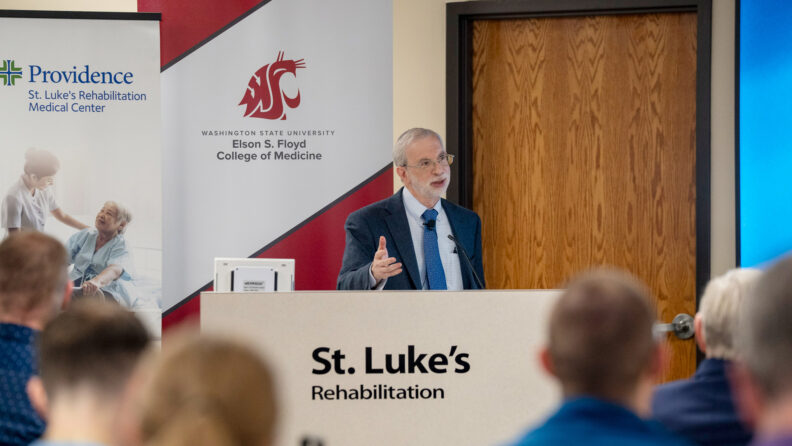 Dr Steven Kirshblum speaking at a podium.