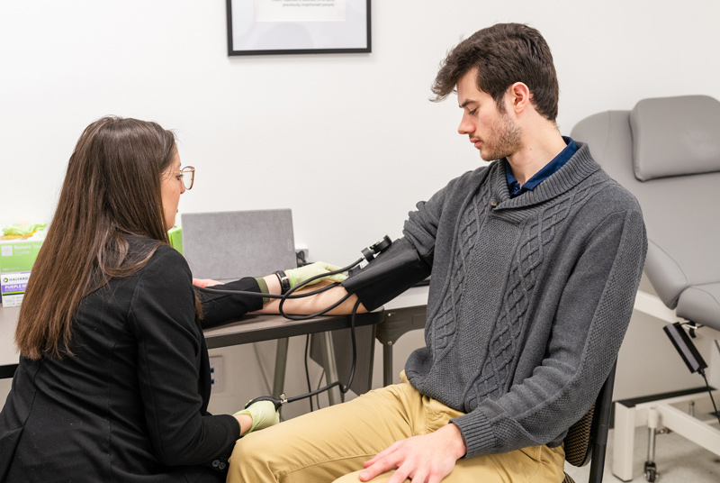 Researcher taking blood pressure reading in the lab.