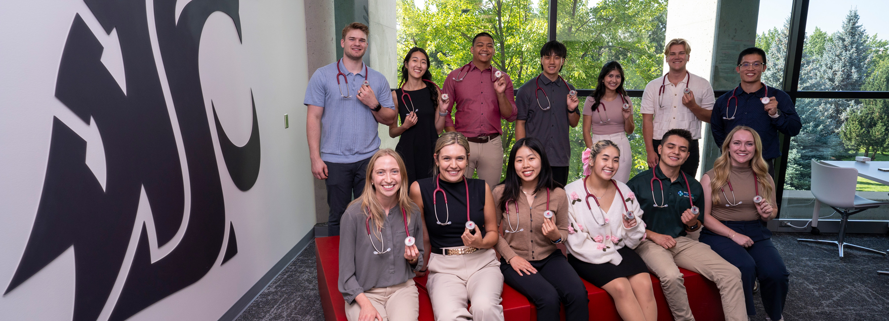 Group on MD students holding their new stethoscopes.
