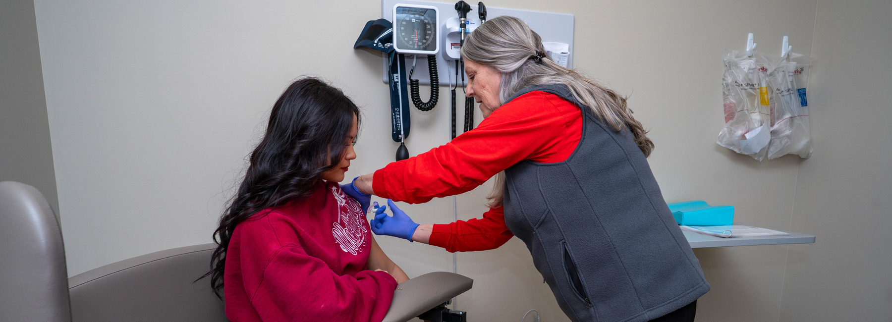 Nurse giving a student a vaccine.