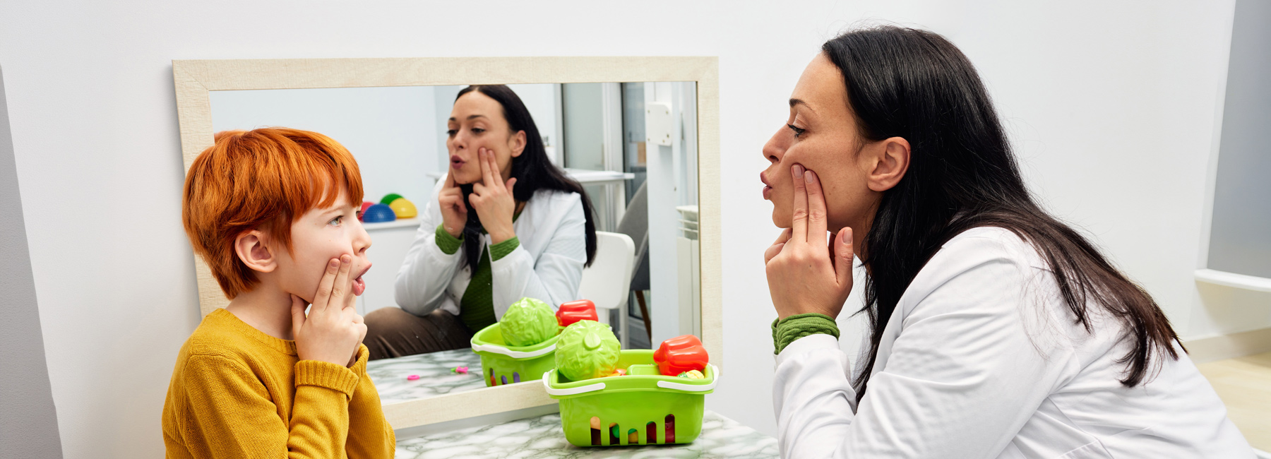 SLP is working with a child doing speech therapy.