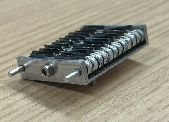 A metalic accordion-style sample holder.