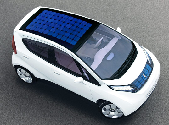 A white sustainably designed car with a solar panel top.