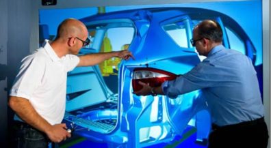 Two engineers working on an automobile frame.