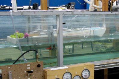 Ship designed to mimic dolphins viewed in a in water channel in a lob. 