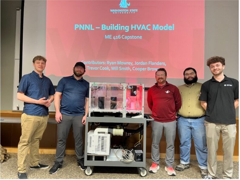 Students in front of a screen that reads PNNL - Building HVAC Model, ME 416 Capstone, Contributors: Ryan Mowrey, Jordan Flanders, Trevor Cook, Will Smith, Cooper Brown.