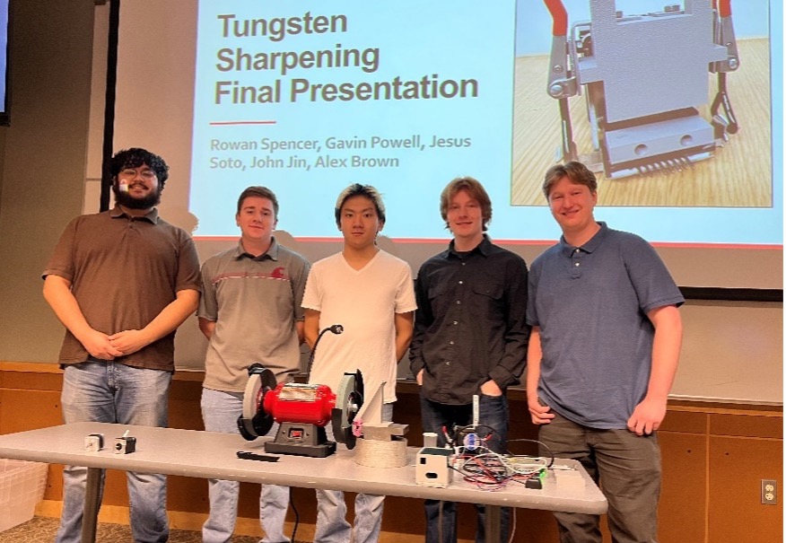 Students in front a a screen that reads Tungsten Sharpening Final Presentation: Rowan Spencer, Gavin Powell, Jesus Soto, John Jin, Alex Brown.