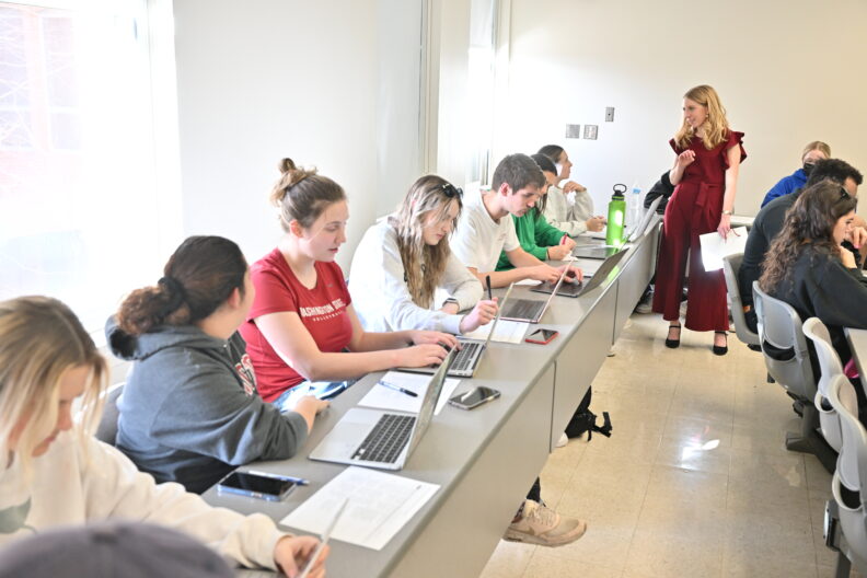 Image of Cara Hawkins-Jedlicka in a classroom interacting with students