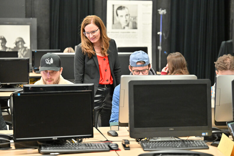 Molly with students on computers
