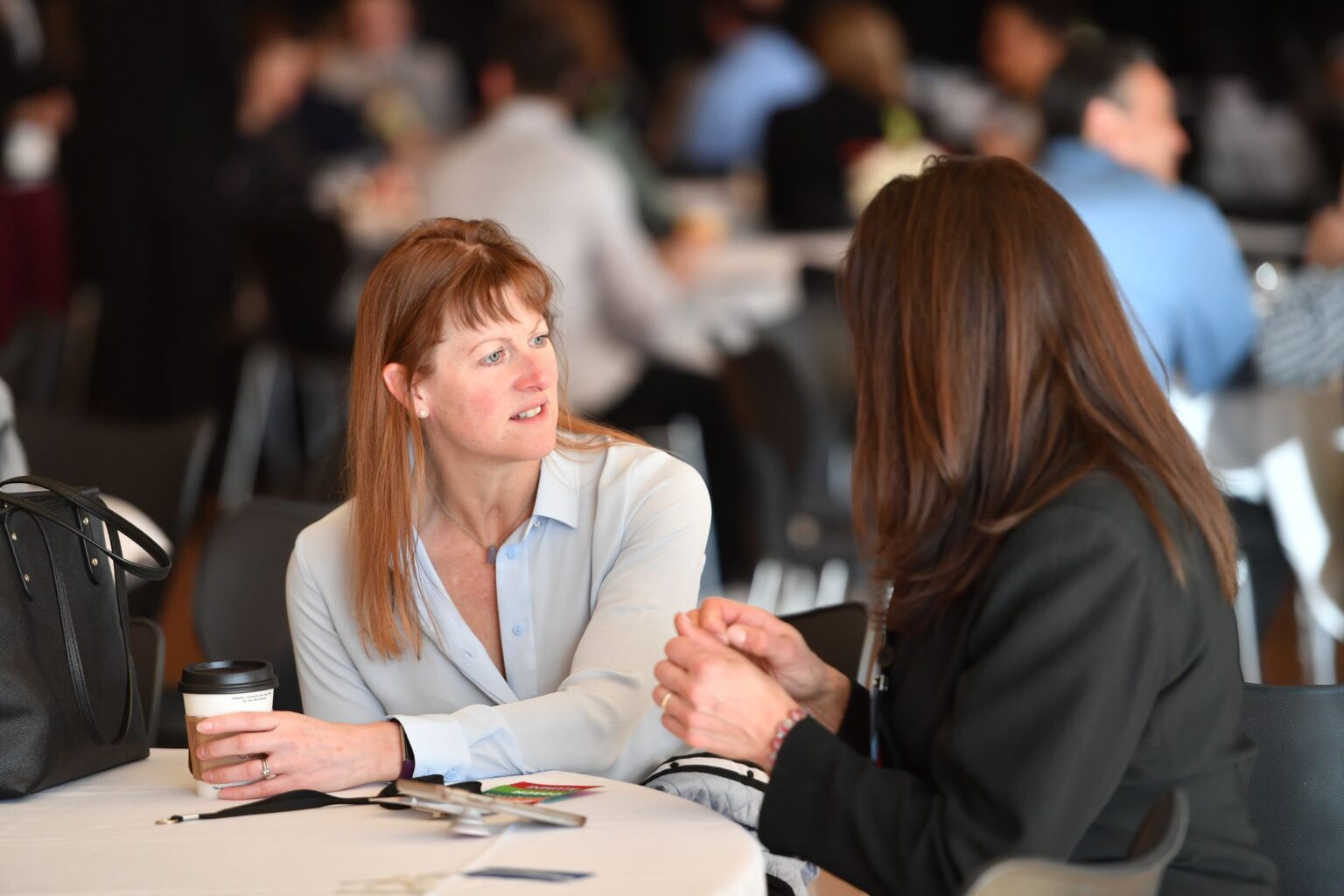 women talking over a cup of coffee