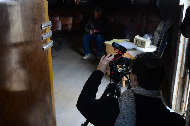 Student Yasmeen taking a picture with a camera