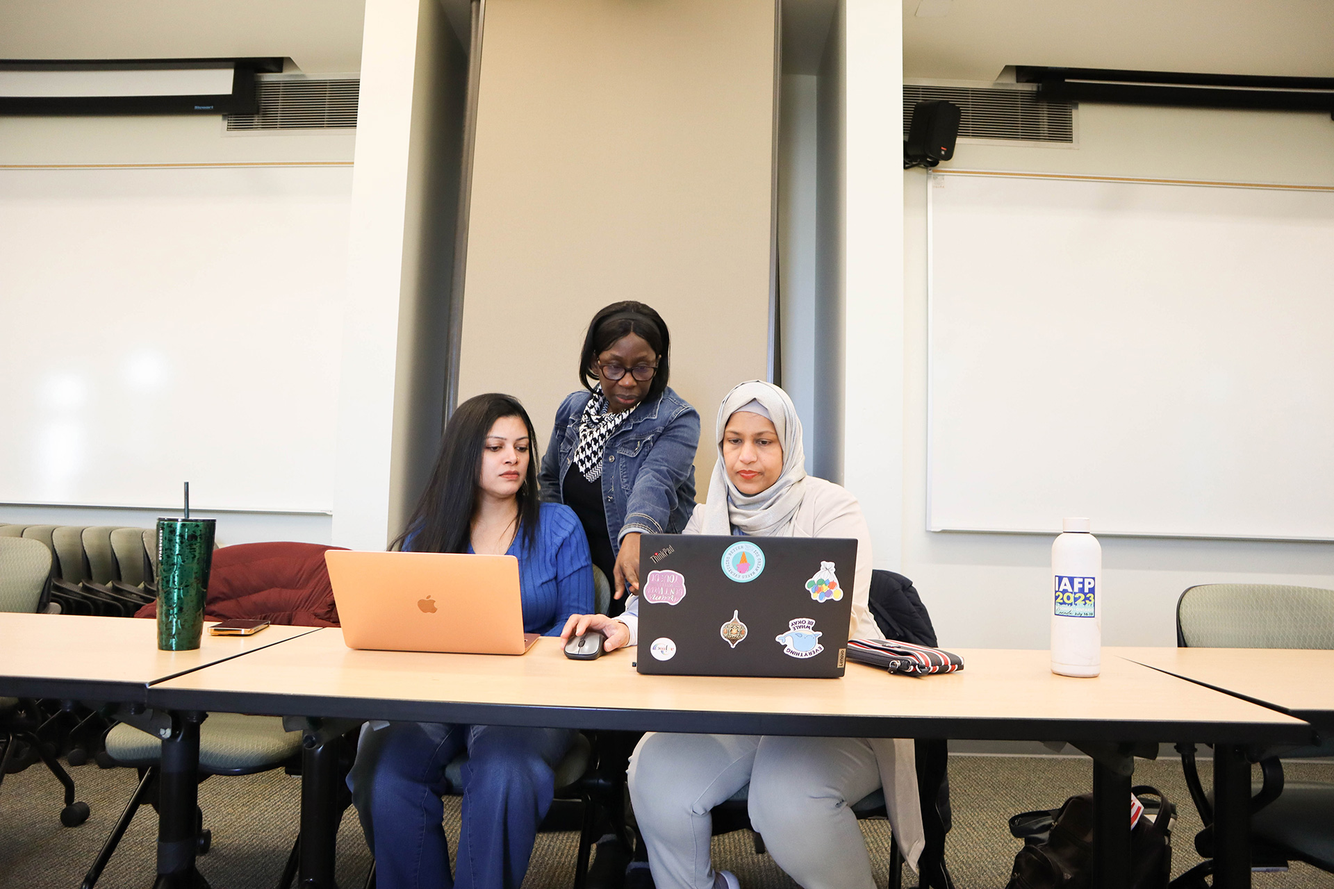 Students working on laptops in the Communication 540 class.