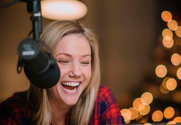 Jaymee Sire smiling in front of mic