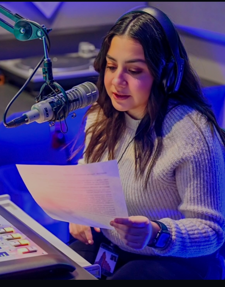 Journalist at mic reading story