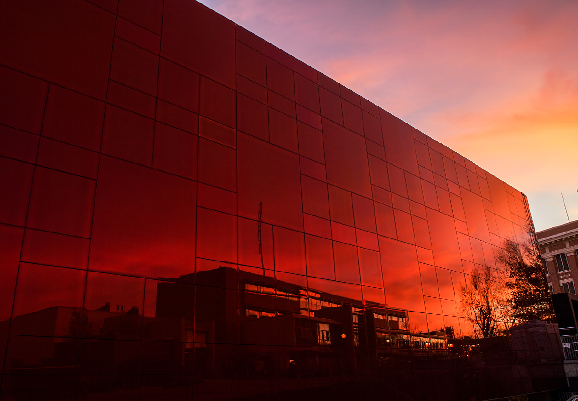 Crimson building facade at sunset.