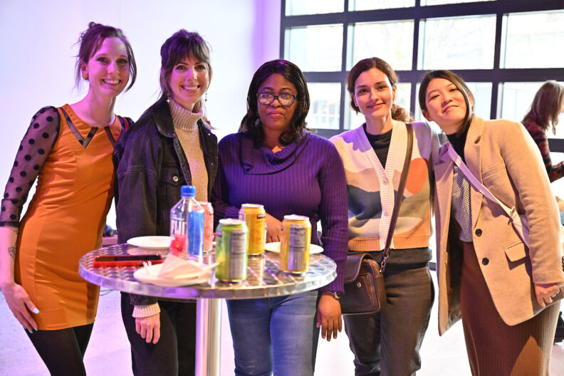 Five people smiling for a photo together in the pavilion gallery.