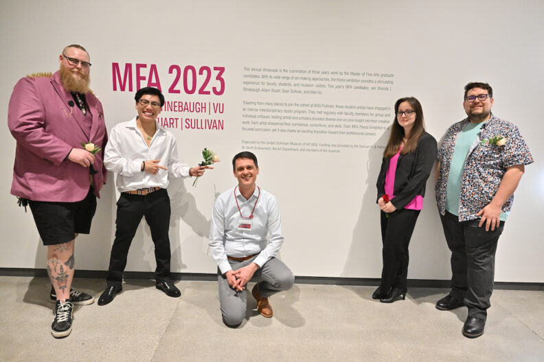 All four MFA candidates gathered around Ryan Hardesty in the museum gallery.