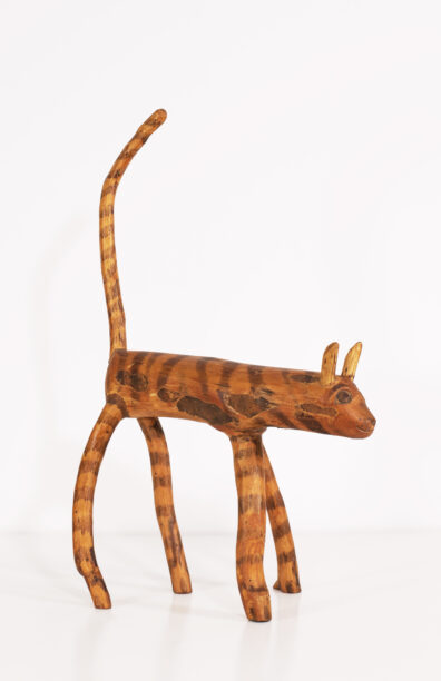 Wooden, striped cat sculpture by artist Vic Moore
